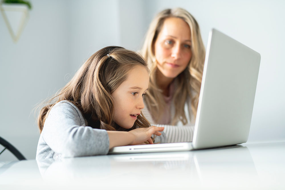 Female with hands on keyboard working on computer